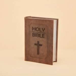 An urn that looks like a bible, brown leather with a cross embossed in the leather
